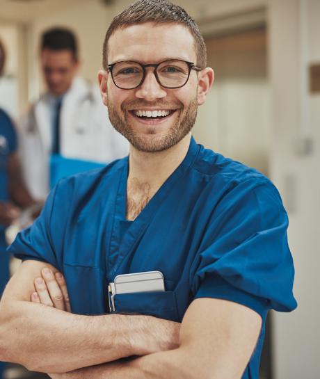 Male nurse smiling with glasses
