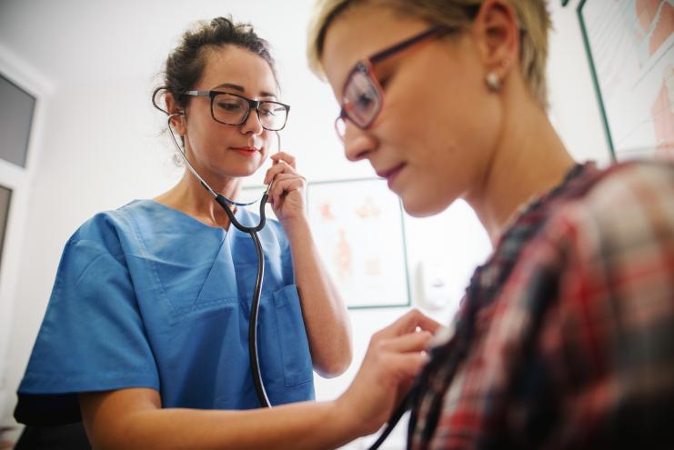 Nurse using stethoscope