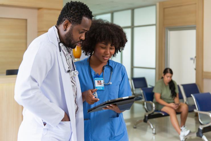 Nurse and doctor reviewing clipboard
