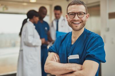 Male nurse smiling with glasses