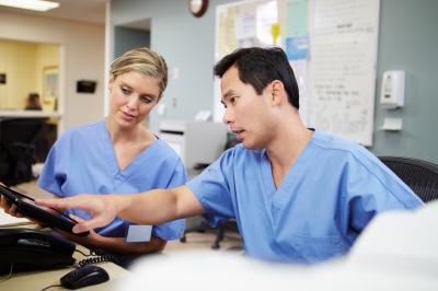 Two nurse colleagues looking at a screen
