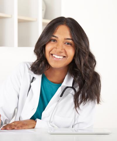 Nurse sitting at desk and writing